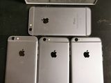 four iphones are sitting next to each other on a table