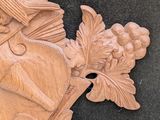 a carving of a man with a hat and a sword