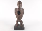 an image of a wooden sculpture of a bird on a stand