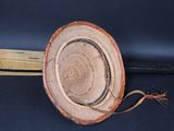 a wooden object that is sitting on a black surface