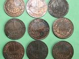 six different types of coins are shown on a green surface