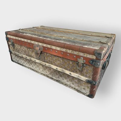 an old trunk sitting on top of a white surface