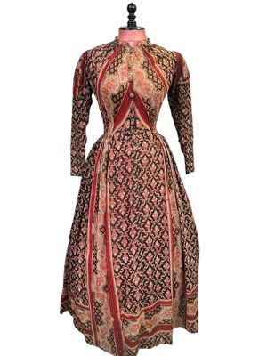 a dress on a mannequin mannequin with a red and black pattern