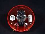 a watch in a plastic case on a black surface
