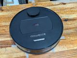 a black lid that is on top of a wooden table