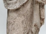 an old statue of a woman holding a baby in her arms