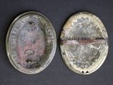 pair of antique silver plated buttons on a black background