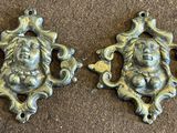 pair of antique cast iron wall plaques of a woman holding a child