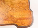 a close up of a wooden table with writing on it