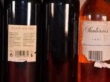 several bottles of wine are lined up on a shelf