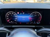 a car dashboard with a digital speedometer and a steering wheel