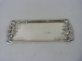 an antique silver plate with a floral design on the edge