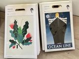 two boxes of ocean line luggage sitting on a table