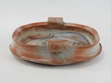 a picture of a brown and white plate with a fish on it
