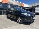 a black ford fiesta parked in front of a building