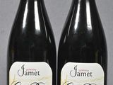 two bottles of wine are sitting next to each other on a table