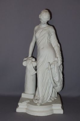 statue of a woman with a basket of flowers on a pedestal