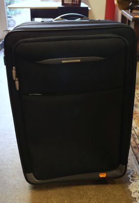 a black suitcase sitting on the floor in a room