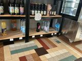 many bottles of beer on the shelves in the store