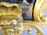 a gold vase with a lion head on top of it