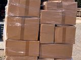 a large stack of boxes sitting on a pallet in the parking lot