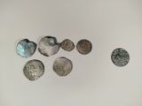 several silver coins sitting on top of a table next to each other