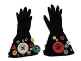 two pairs of black gloves with buttons and buttons on them