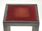 a small table with a red square on it