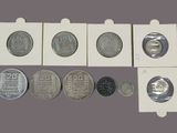 six different types of coins in a white box on a purple background