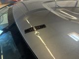 a close up of a car with a sticker on the hood