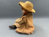 an image of a figurine of a child wearing a straw hat