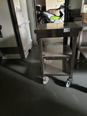 a metal cart that is sitting in the middle of a room