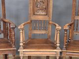 three wooden chairs with carvings on the back of them