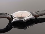 an image of a close up of a watch on a black surface