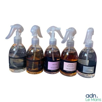 several bottles of different types of cleaning products lined up on a white surface