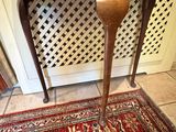 a small table with a vase on top of it