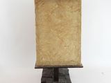 a lamp that is on top of a wooden stand