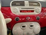 a red and white car dashboard with a digital clock on it