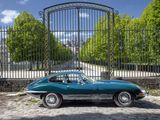 a green car that is parked in front of a gate
