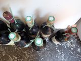 several bottles of wine are lined up on a counter top
