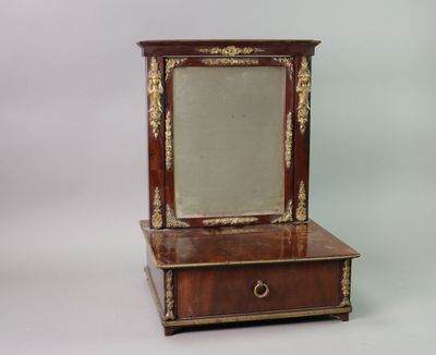 a small mirror sitting on top of a wooden dresser