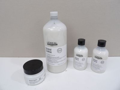 a bottle of lotion and two bottles of lotion sitting on a table