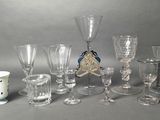 a lot of glasses and cups sitting on a table