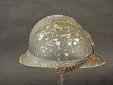 a helmet on a stand with a rope around it