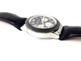 a watch that is sitting on a black leather strap