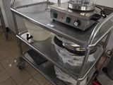 a kitchen with a sink and a metal cart