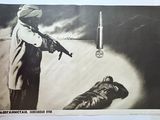 an old poster of a man holding a gun next to a sleeping man