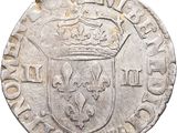 a silver coin with a crown on top of it