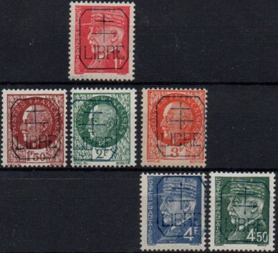 a close up of a group of stamps on a black surface
