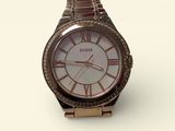 a close up of a wrist watch on a white surface